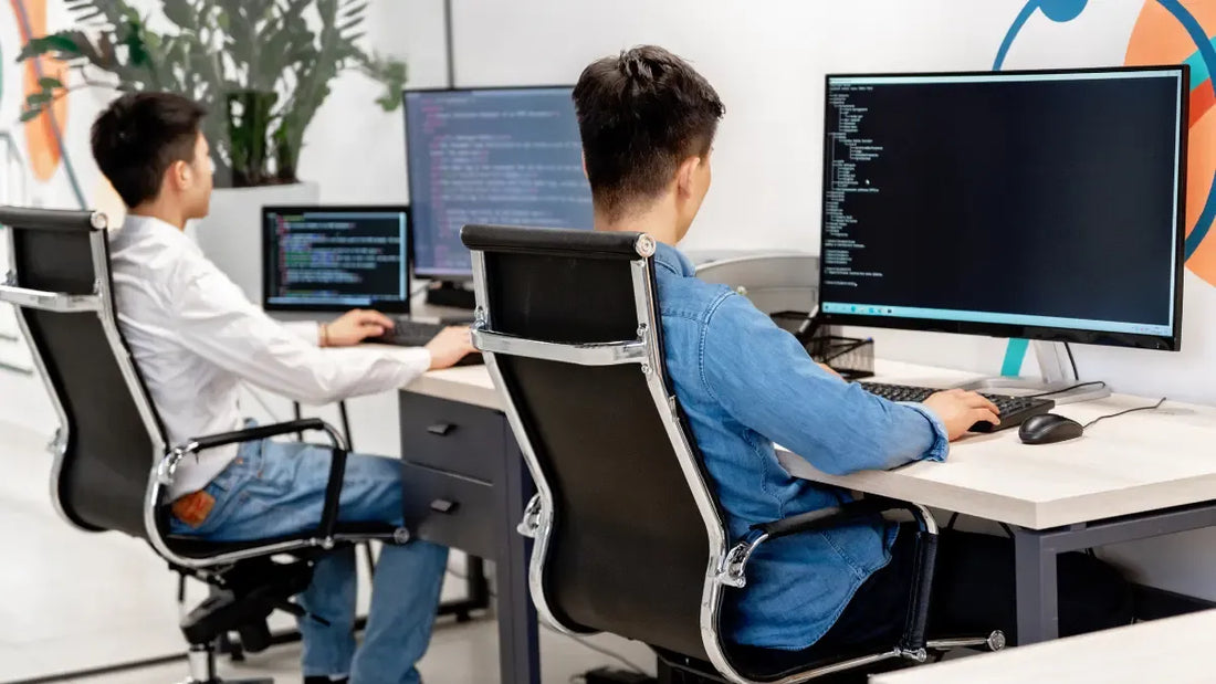 Employee sitting in a used ergonomic office chair at a modern workspace in New Jersey.